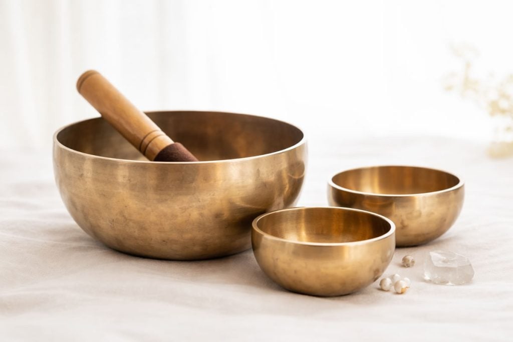 Royalty-Free Tibetan Singing Bowl Music for Deep Meditation 9 Tibetan singing bowls and mallet on a clean white background, used for meditation, sound healing, and deep relaxation.